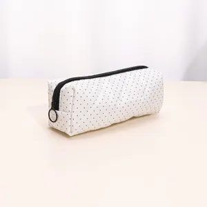 White quilted makeup bag pencil case with black polka dots zipper closure detail view