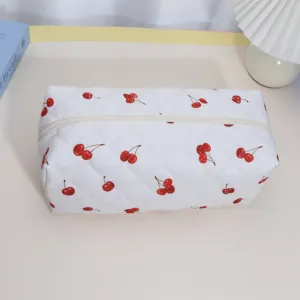 Quilted white cherry print storage bag detail, spacious cosmetic and hair tool pouch organizer.