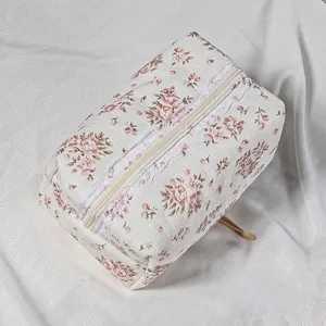 Quilted floral cosmetic bag detail, vintage lace trim zipper makeup pouch for women storage.