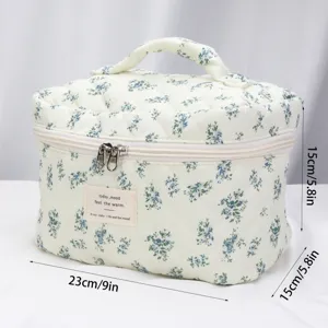 Quilted floral cosmetic bag with zip and handle, portable travel makeup storage pouch.