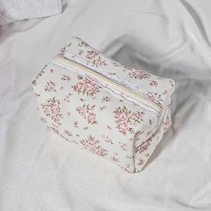 Quilted floral cosmetic bag with lace trim, vintage style small zipper makeup pouch detail.