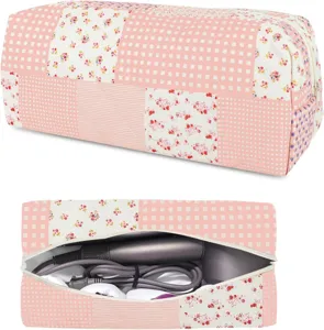 Detailed view of pink quilted patchwork storage pouch interior with hair dryer and cord space.