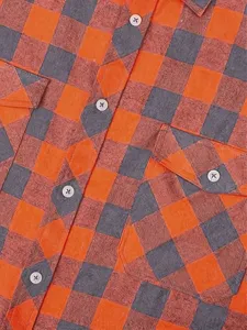 Close-up detail of men's casual flannel plaid shirt, showing texture, buttons and chest pocket.