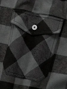 Men's flannel plaid shirt detail showcasing classic grey pattern, pocket and button.