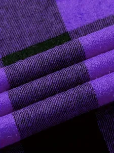 Close-up detail of purple and black plaid flannel fabric showing fine twill texture.