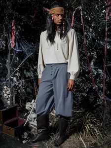 Detailed close-up view of medieval pirate Gothic men's casual pants in dark forest backdrop.