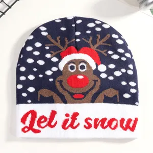 Detail view of a navy blue Christmas knit beanie featuring a cute reindeer and snow pattern, cozy hat.