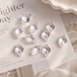 Detailed close-up of clear double-hole diamond crystal glass beads for DIY jewelry making.