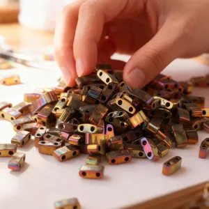 Close-up detail shot of metallic dual-hole DIY beads featuring a vibrant rainbow finish.