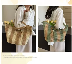 Woven straw tote bag for women, large capacity shoulder bag with stylish tassel pendant.