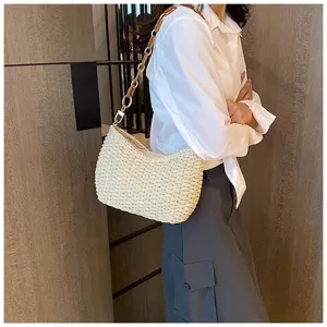 Woven straw shoulder bag for women, stylish beach hobo handbag with chic chain strap design.