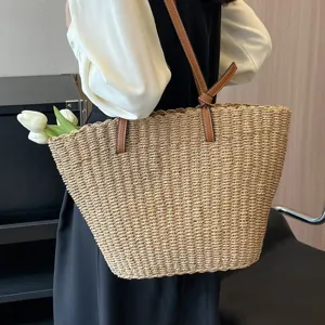 Summer straw woven tote bag with brown leather straps and stylish knot detail for women.