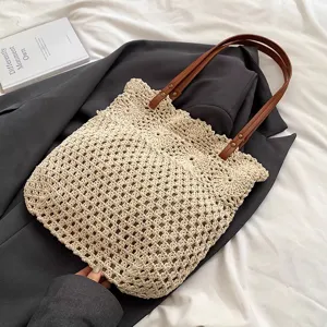 Beige crochet woven tote bag with brown leather handles, casual beach shoulder bag.