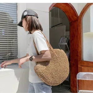 Woven straw shoulder bag for women, large capacity round beach handbag for casual vacation summer use.