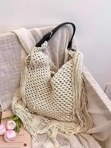 Handmade crochet fringe shoulder bag for women, chic cotton woven tote for beach and vacation.