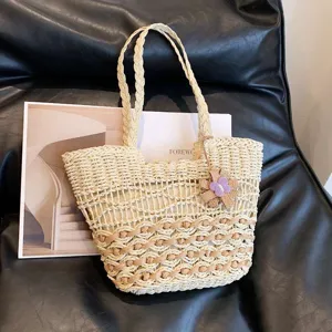 Bohemian straw woven tote bag, large capacity beach shoulder bag with floral pendant for summer.