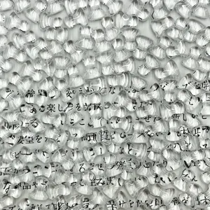 Close-up detail shot of transparent glass bone beads, showing clear texture and brilliant shine.
