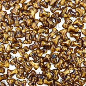 Closeup detail of Czech glass bone beads in brown mottled color for DIY accessories.