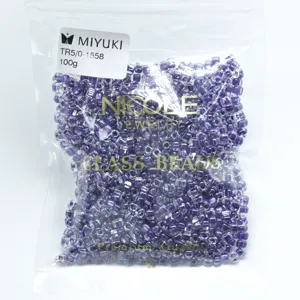 Detail view of Miyuki TR5/0 triangle glass seed beads in purple, 100g pack for DIY jewelry.