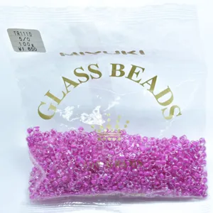 Close-up detail of Japanese Miyuki glass seed beads in pink triangle shape, 5mm 100g.