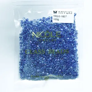 Detailed view of Miyuki TR5/0 triangle glass beads in 100g pack, ideal for jewelry crafting.
