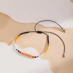Adjustable handmade beaded bracelet with black woven cord and colorful seed beads for women.