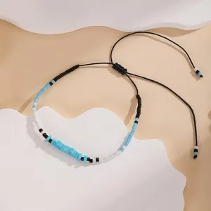 Detailed view of handmade Miyuki seed bead braided bracelet with adjustable black cord design.
