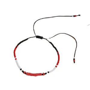 Minimalist handmade seed bead bracelet with adjustable black cord, stylish red and white design.