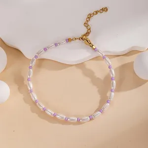 Elegant beaded pearl bracelet detail shot showcasing white and purple bead mix design.
