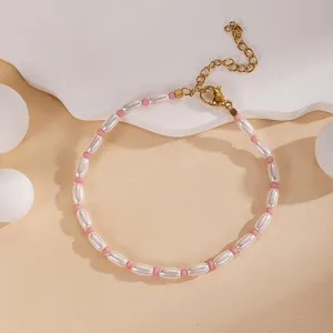 Elegant minimalist beaded bracelet with white and pink pearls, adjustable gold chain.