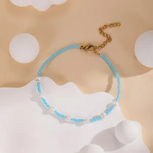 Handcrafted blue seed bead pearl bracelet with adjustable gold chain detail for summer style.