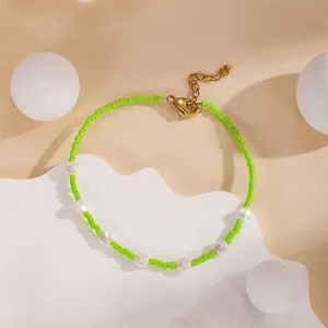 Green seed bead and pearl bracelet detail view, showcasing the adjustable gold-tone clasp link.