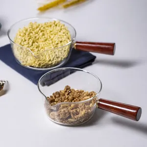 Clear heat resistant glass bowl with wooden handle for kitchen salad and instant noodles.