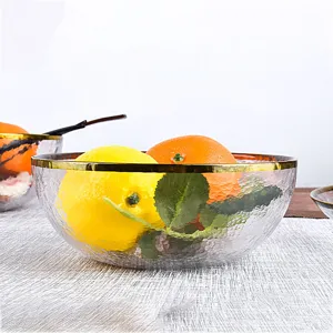 Clear glass fruit salad bowl with elegant gold rim and hammered texture for home kitchen dining.