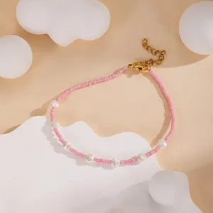 Minimalist handmade pink seed bead and pearl bracelet detail closeup showing delicate gold clasp.