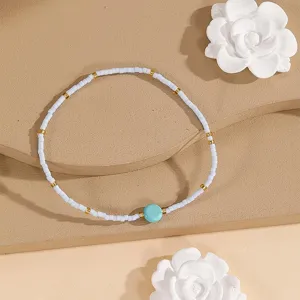 Minimalist beaded bracelet with turquoise stone and white seed beads, delicate handmade jewelry.