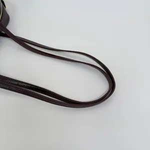 Close-up detail of dark brown leather handbag straps with clean stitching and smooth edge finish.