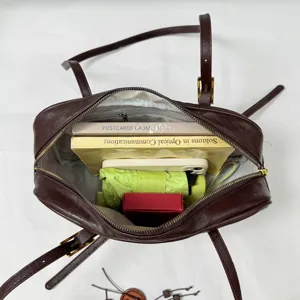 Brown leather Boston bag interior detail, showcasing large capacity, commuter casual style.