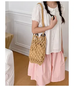 Detailed view of stylish hollow cotton woven bucket bag with net design for women fashion.