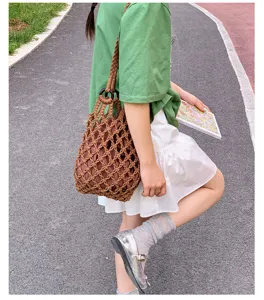 Chic cotton woven handbag for women, trendy hollow bucket bag and stylish net shoulder bag.