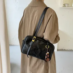 Detailed view of Korean style retro black Boston shoulder bag with chic strap and charm pendant.