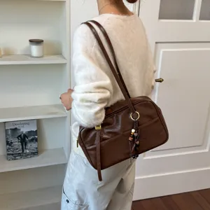 Korean retro brown Boston shoulder bag, classic commuter handbag with long strap and charm.