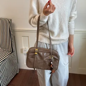 Korean retro brown boston shoulder bag with long strap and chic pendant charm for daily use.