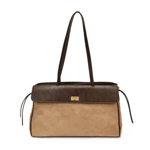 Vista dettagliata della borsa a spalla matelassé marrone chic con chiusura a girello e cinturini.