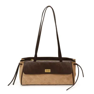Vista dettagliata di elegante borsa a spalla matelassé con chiusura in metallo e spallacci fini.