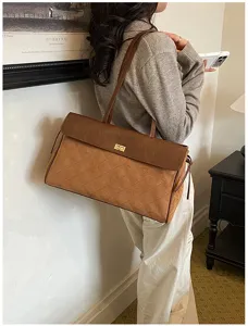 Vista dettagliata della elegante borsa a spalla marrone trapuntata con cuciture raffinate.