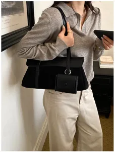 Casual large capacity black shoulder bag with chic flap design and small pouch detail.