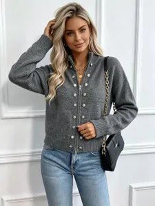Close-up view of a chic grey knit zip cardigan featuring elegant decorative metal buttons detail.