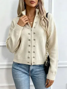 Detailed view of women cream knit cardigan with metallic buttons, zipper and ribbed collar.