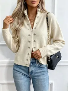 Close-up detail of women's off-white knit zip cardigan with metal buttons and high collar.